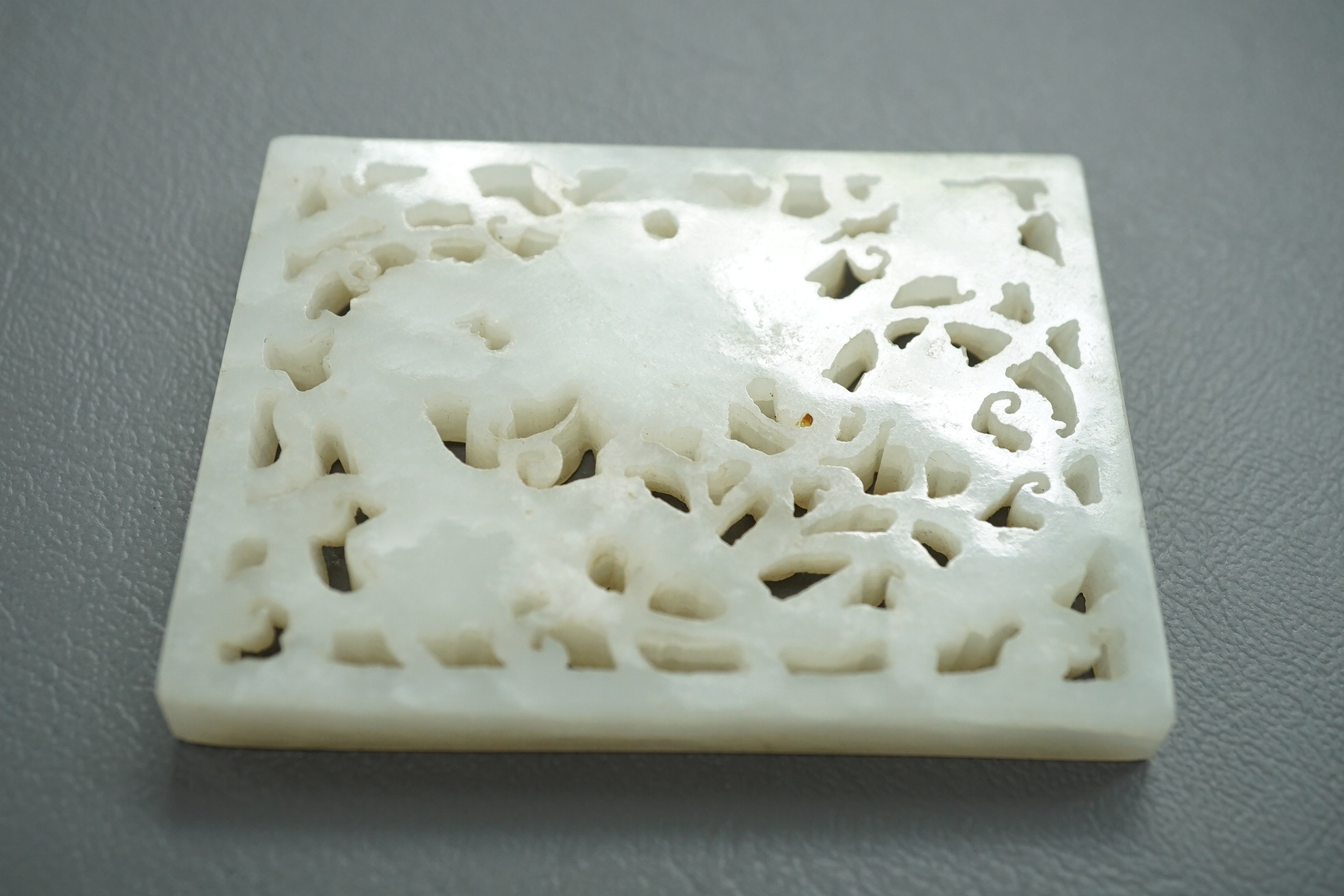 A Chinese white and black jade figure of a recumbent tiger, Song dynasty